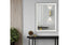 White French provincial ornate mirror styled on wall with black console and gold décor.