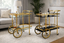 Gold glass drink trolleys styled with bottles and glassware perfect for chic home entertaining