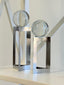 Silver glass sphere décor pair styled on shelf with soft lighting.