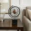 Decorative globe table decor on a table next to a lamp and sofa