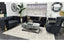 GRAND black velvet tufted lounge set with 3-seater, 2-seater, and wing chair featuring gold and silver legs in a luxury showroom setting