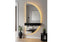 Black half moon LED mirror with shelf styled in entryway adding warm light and modern elegance