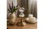 Decorative table setting with a gold hourglass decor, purple flowers, and candles.