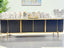 Kingsley TV Unit in black with gold trim, styled in modern living room setting.