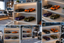 A collage of six views showing toy sports cars displayed on built-in shelves with warm LED lighting in a modern children's bedroom. The cars include black, orange, purple, and olive green models, shown in different room configurations.
