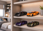 Four toy sports cars in black, orange, purple, and olive green displayed on light wood shelves in a modern bedroom setting.