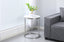 Layla side table with silver frame and marble top styled beside a contemporary sofa.
