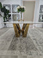 Lenox Dining Table with gold stainless frame and marble top styled with floral décor.