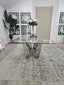 Lenox Dining Table silver stainless frame with clear tempered glass top styled in dining area.