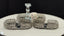 Sophisticated silver Lucy trays arranged beautifully with a mirrored base and floral accents for refined décor styling.