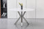 Miles round dining table with polished silver frame and marble top, versatile dining option.