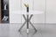 Miles round dining table with polished silver frame and marble top, versatile dining option.