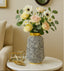 Decorative vase with flowers on a marble table in a living room setting