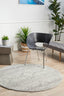 Round Mirage 358 Silver Rug styled with modern black chair and indoor plants