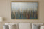 Abstract painting with vertical lines with a hint of gold lines on a beige wall above a sofa.
