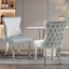 Pair of Paris light grey velvet dining chairs with tufted backs and silver legs, styled in a modern dining room.