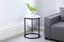 Romana Side Table styled in a modern living room with black frame and white marble top.