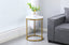 Romana Side Table in a living room setting with champagne frame and white marble top.