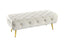 Beige Shirley Ottoman with gold polished frame and tufted velvet cushion for versatile style.