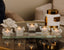 Set of crystal candle holders with lit candles on a reflective surface, with a blurred background.