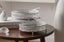 Two silver decorative mirror trays on a wooden table with a neutral background