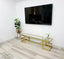 Alexa TV Unit gold frame with clear glass styled with décor under mounted television