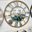 Decorative gold beaded mirrored Roman numeral wall clock displayed in showroom with mirrors.
